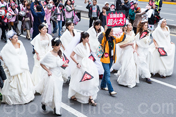 民進黨13日在台北舉辦火大遊行,民眾帶穿著婚紗走上街頭,對政府表達心中的不滿。(攝影:陳柏州/大紀元) 民進黨13日在台北舉辦火大遊行,民眾帶穿著婚紗走上街頭,對政府表達心中的不滿。(攝影:陳柏州/大紀元)
