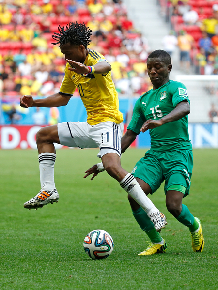 BRASILIA, BRAZIL - JUNE 19: Juan Guillermo Cuadrado of Colombia is challenged by Max Gradel of the Ivory Coast during the 2014 FIFA World Cup Brazil Group C match between Colombia and Cote D'Ivoire at Estadio Nacional on June 19, 2014 in Brasilia, Brazil. (Photo by Gabriel Rossi/Getty Images) BRASILIA, BRAZIL - JUNE 19: Juan Guillermo Cuadrado of Colombia is challenged by Max Gradel of the Ivory Coast during the 2014 FIFA World Cup Brazil Group C match between Colombia and Cote D'Ivoire at Estadio Nacional on June 19, 2014 in Brasilia, Brazil. (Photo by Gabriel Rossi/Getty Images)