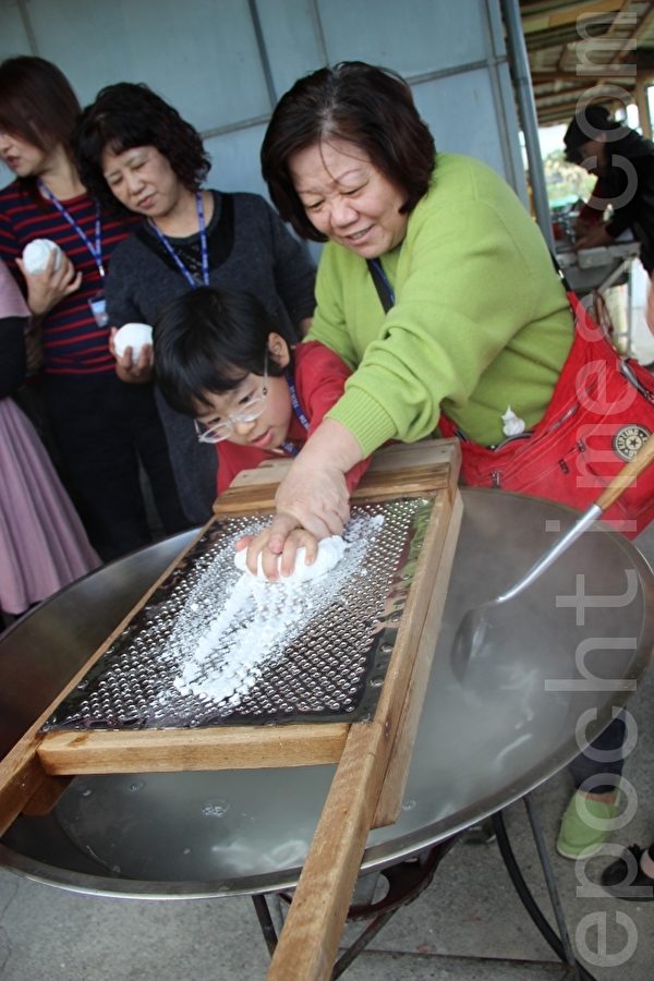 由米浆粉团过筛变成条状的米苔目,下面以沸水煮熟定型。(谢月琴/大纪元) 由米浆粉团过筛变成条状的米苔目,下面以沸水煮熟定型。(谢月琴/大纪元)