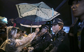 人性的光輝 香港學生風雨中為警察撐傘