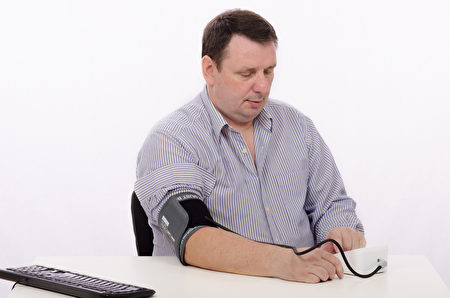 Middle aged man with blood pressure machine Middle aged man with blood pressure machine