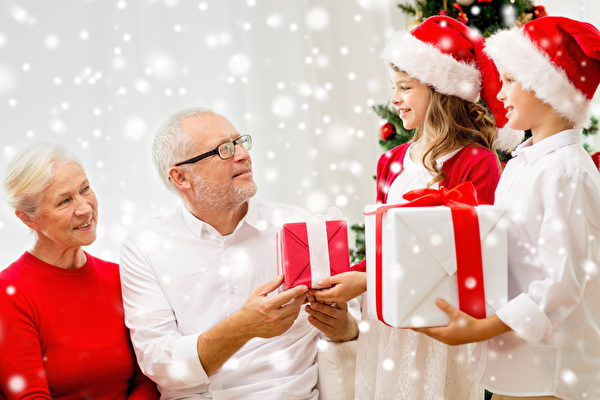 smiling family with gifts at home