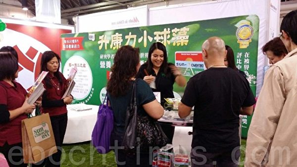 华人工商展现场,民众试吃具排毒及营养功效的保健品小球藻。(徐绣惠/大纪元) 华人工商展现场,民众试吃具排毒及营养功效的保健品小球藻。(徐绣惠/大纪元)