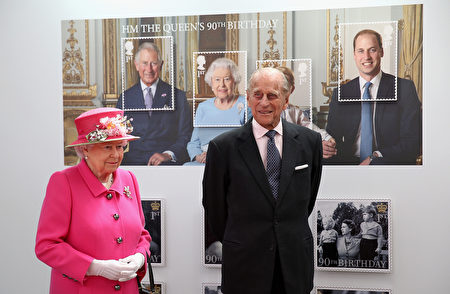 Britain's Queen Elizabeth II (L) and Britain's Prince Philip, Duke of Edinburgh pass a giant photograph taken to be used as part of a series of 10 Royal Mail postage stamps, to mark the monarch's 90th birthday, during her tour of the Royal Mail Windsor postal delivery office in Windsor, west of London, on April 20, 2016, to mark the 500th anniversary of the Postal Service. Queen Elizabeth II is set to celebrate her 90th birthday on April 21, with a family gathering and a cake baked by a reality television star, as a new poll finds Britain's longest serving monarch is as popular as ever. The queen has reigned for more than 63 years and shows no sign of retiring, even if she has in recent years passed on some of her duties to the younger royals. / AFP / POOL / Chris Jackson (Photo credit should read CHRIS JACKSON/AFP/Getty Images)