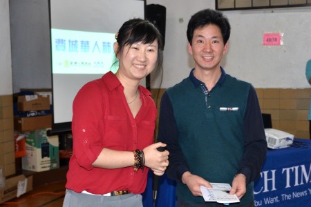 参展商西安美食老板王心平先生有幸中得Reboot健康中心脊椎治疗师尚蒙医生(左)捐助的奖品— $60 的针灸治疗卡。(良克霖/大纪元)