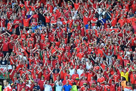 Wales' fans celebrate their team's victory during the Euro 2016 round of sixteen football match Wales vs Northern Ireland, on June 25, 2016 at the Parc des Princes stadium in Paris. / AFP / MIGUEL MEDINA (Photo credit should read MIGUEL MEDINA/AFP/Getty Images)