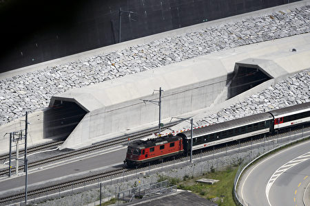 A train makes its way at the north entrance of the new Gotthard Base Tunnel the world's longest train tunnel on the eve of its opening ceremony on May 31, 2016 in Erstfeld. The new Gotthard Base Tunnel (GBT) is set to become the world's longest railway tunnel when it opens on June 1.The 57-kilometre (35.4-mile) tunnel, which runs under the Alps, was first conceived in sketch-form in 1947 but construction began 17 years ago. / AFP / FABRICE COFFRINI (Photo credit should read FABRICE COFFRINI/AFP/Getty Images)