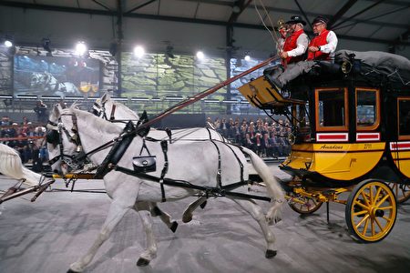 People perform on the old Gotthard diligence during the opening show directed by German director Volker Hesse, on the opening day of the Gotthard rail tunnel, the longest rail tunnel in the world, at the fairground Rynaecht at the northern portal in Erstfeld, Switzerland, on June 1, 2016. The new Gotthard Base Tunnel (GBT) is set to become the world's longest railway tunnel when it opens on June 1. The 57-kilometre (35.4-mile) tunnel, which runs under the Alps, was first conceived in sketch-form in 1947 but construction began 17 years ago. / AFP / POOL / PETER KLAUNZER (Photo credit should read PETER KLAUNZER/AFP/Getty Images)