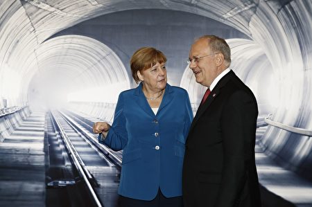 Swiss President Johann Schneider-Ammann (R) speaks with German Chancellor Angela Merkel on the opening day of the Gotthard rail tunnel, the world's longest railway tunnel in the world, at the fairground Rynaecht at the northern portal in Erstfeld, Switzerland, on June 1, 2016. The new Gotthard Base Tunnel (GBT) is set to become the world's longest railway tunnel when it opens on June 1.The 57-kilometre (35.4-mile) tunnel, which runs under the Alps, was first conceived in sketch-form in 1947 but construction began 17 years ago. / AFP / POOL / PETER KLAUNZER (Photo credit should read PETER KLAUNZER/AFP/Getty Images)