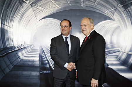 Swiss President Johann Schneider-Ammann (R) shakes hands with French President Francois Hollande on the opening day of the Gotthard rail tunnel, the world's longest railway tunnel in the world, at the fairground Rynaecht at the northern portal in Erstfeld, Switzerland, on June 1, 2016. The new Gotthard Base Tunnel (GBT) is set to become the world's longest railway tunnel when it opens on June 1.The 57-kilometre (35.4-mile) tunnel, which runs under the Alps, was first conceived in sketch-form in 1947 but construction began 17 years ago. / AFP / POOL / PETER KLAUNZER (Photo credit should read PETER KLAUNZER/AFP/Getty Images)