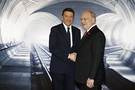 Swiss President Johann Schneider-Ammann (R) shakes hands with Italian Prime Minister Matteo Renzi on the opening day of the Gotthard rail tunnel, the world's longest railway tunnel in the world, at the fairground Rynaecht at the northern portal in Erstfeld, Switzerland, on June 1, 2016. The new Gotthard Base Tunnel (GBT) is set to become the world's longest railway tunnel when it opens on June 1.The 57-kilometre (35.4-mile) tunnel, which runs under the Alps, was first conceived in sketch-form in 1947 but construction began 17 years ago. / AFP / POOL / PETER KLAUNZER (Photo credit should read PETER KLAUNZER/AFP/Getty Images)