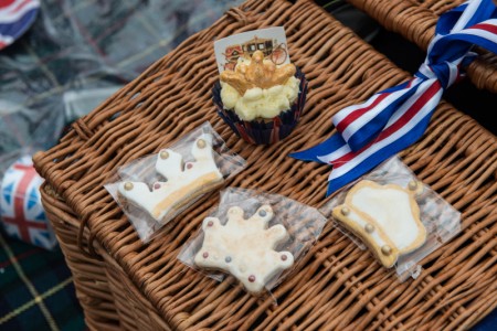 LONDON, ENGLAND - JUNE 12: Homemade cakes and biscuits are seen on a wicker hamper basket as members of the public gather in the rain in Green Park for a picnic and to watch The Queen's Patronage on a big screen during "The Patron's Lunch" celebrations for The Queen's 90th birthday on June 12, 2016 in London, England. 10,000 guests have gathered on The Mall for a lunch to celebrate The Queen's Patronage of more than 600 charities and organisations. The lunch is part of a weekend of celebrations marking Queen Elizabeth II's 90th birthday and 63 year reign. The Duke of Edinburgh and other members of The Royal Family are also in attendance. During the lunch a carnival parade will travel down The Mall and around St James's Park. (Photo by Chris Ratcliffe/Getty Images)