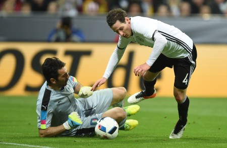 Italian goalkeeper Gianliugi Buffon (L) fouls Germany's defender Sebastian Rudy to give away a penalty during the friendly football match Germany vs Italy in Muinch, southern Germany, on March 29, 2016. / AFP / CHRISTOF STACHE (Photo credit should read CHRISTOF STACHE/AFP/Getty Images)