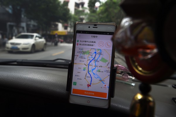 2016年5月,广西桂林,一名司机在使用滴滴出行软件载客。 (GREG BAKER/AFP/Getty Images)