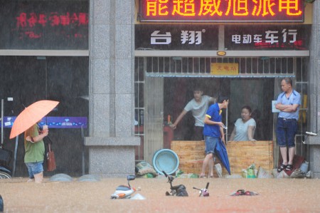 JIUJIANG, CHINA - JUNE 15: (CHINA OUT) Citizens walk in flood caused by rainstorms on June 15, 2016 in Jiujiang, Jiangxi Province of China. Heavy rainstorms continued to fall in many parts of China causing floods in Hunan, Henan, Guangxi, Guizhou, Guangdong and other places these days. (Photo by Hu Guolin/Getty Images)