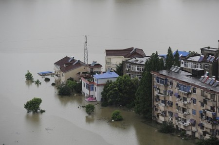 This picture taken on July 5, 2016 shows trees and houses submerged by floodwaters in Zongyang county, in east China's Anhui province. Heavy rain around China's Yangtze river basin has left 128 people dead and scores missing, media said on July 5, with more damage feared from a typhoon expected to land this week. / AFP / STR / China OUT (Photo credit should read STR/AFP/Getty Images)
