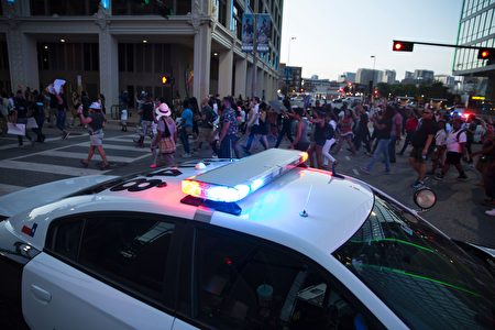People rally in Dallas, Texas, on Thursday, July 7, 2016 to protest the deaths of Alton Sterling and Philando Castile. Black motorist Philando Castile, 32, a school cafeteria worker, was shot at close range by a Minnesota cop and seen bleeding to death in a graphic video shot by his girlfriend that went viral Thursday, the second fatal police shooting to rock America in as many days. / AFP / Laura Buckman (Photo credit should read LAURA BUCKMAN/AFP/Getty Images)