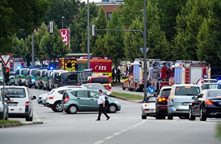 Police and firefighters are seen near a shopping mall amid a shooting on July 22, 2016 in Munich. Several people were killed on Friday in a shooting rampage by a lone gunman in a Munich shopping centre, media reports said / AFP / dpa / Matthias Balk / Germany OUT (Photo credit should read MATTHIAS BALK/AFP/Getty Images)