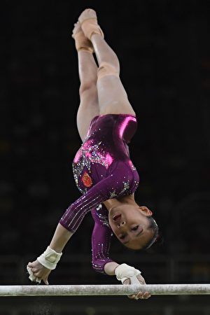 China's Fan Yilin competes in the Uneven Bars event during the women's team final Artistic Gymnastics at the Olympic Arena during the Rio 2016 Olympic Games in Rio de Janeiro on August 9, 2016. / AFP / Ben STANSALL (Photo credit should read BEN STANSALL/AFP/Getty Images)