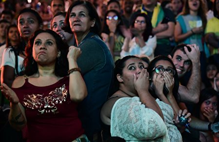 Fans watch the Rio 2016 Olympic Games men's football gold medal match between Brazil and Germany at the Olympic Boulevard in Rio de Janeiro, Brazil on August 20, 2016. / AFP / TASSO MARCELO (Photo credit should read TASSO MARCELO/AFP/Getty Images)