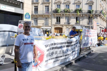 負責產品推廣的主管Pascal Gérome先生為法輪功反迫害簽名支持。(金湖/大紀元)