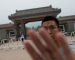 To go with AFP story China-politics-corruption-Bo-prison,FOCUS by Tom Hancock
In a photo taken on September 12, 2013 a plainclothes policeman attempts to stop photos from being taken at the entrance to Qincheng prison on the outskirts of Beijing. Fallen high-flyer Bo Xilai can expect hotel-style treatment at a jail for China's political elite, where he will enjoy comfortable surroundings but be constantly monitored by government agents, former prisoners say. AFP PHOTO / Ed Jones (Photo credit should read Ed Jones/AFP/Getty Images)