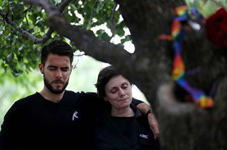 NEW YORK, NY - JUNE 16: People embrace after tying ribbons on the Survivor Tree at the National September 11 Memorial & Museum in honor of the victims of the Orlando nightclub attack on June 16, 2016 in New York City. Hundreds of people tied colored ribbons on the Survivor Tree at the National September 11 Memorial & Museum to honor the victims of the terror attack at the Pulse nightclub in Orlando over the weekend that left 49 dead. (Photo by Justin Sullivan/Getty Images)