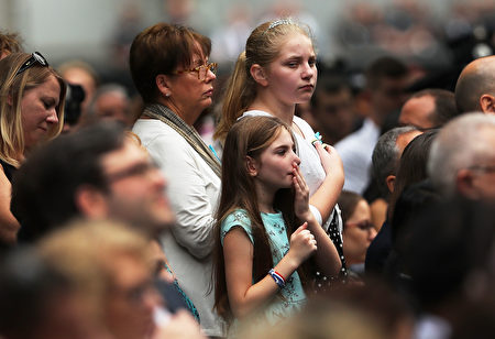 NEW YORK, NY - SEPTEMBER 11: A child pauses during a commemoration ceremony for the victims of the September 11 terrorist attacks at the National September 11 Memorial and Museum fifteen years after the day on September 11, 2016 in New York City. Throughout the country services are being held to remember the 2,977 people who were killed in New York, the Pentagon and in a field in rural Pennsylvania. (Photo by Spencer Platt/Getty Images)