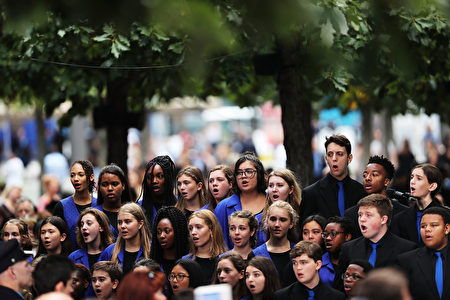 NEW YORK, NY - SEPTEMBER 11: A choir sings as family members, emergency workers and others attend commemoration ceremony for the victims of the September 11 terrorist attacks at the National September 11 Memorial and Museum fifteen years after the day on September 11, 2016 in New York City. Throughout the country services are being held to remember the 2,977 people who were killed in New York, the Pentagon and in a field in rural Pennsylvania. (Photo by Spencer Platt/Getty Images)