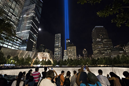 NEW YORK, NY - SEPTEMBER 11: People gather around the National September 11th Memorial as the "Tribute in Light" illuminates the night sky, September 11, 2016 in New York City. Throughout the country services are being held to remember the 2,977 people who were killed in New York, at the Pentagon and in a field in rural Pennsylvania. (Photo by Drew Angerer/Getty Images)