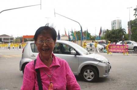 當地老居民黃女士十分開心看到法輪功的遊行。(明慧網)