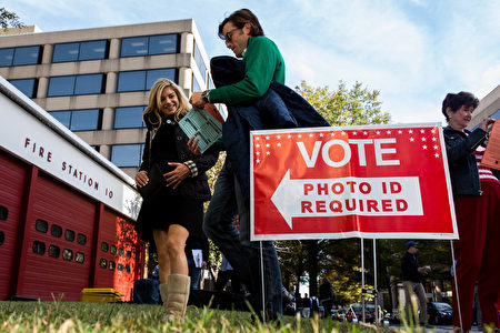 ARLINGTON, VA - NOVEMBER 08: People make their way into Fire Station 10 to vote in the 2016 election on November 8, 2016 in Arlington, Virginia. Americans across the nation are picking their choice for the next president of the United States. (Photo by Zach Gibson/Getty Images)