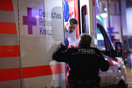BERLIN, GERMANY - DECEMBER 19: Police speak to an ambulance near the area after a lorry truck ploughed through a Christmas market on December 19, 2016 in Berlin, Germany. Several people have died while dozens have been injured as police investigate the attack at a market outside the Kaiser Wilhelm Memorial Church on the Kurfuerstendamm and whether it is linked to a terrorist plot. (Photo by Sean Gallup/Getty Images)