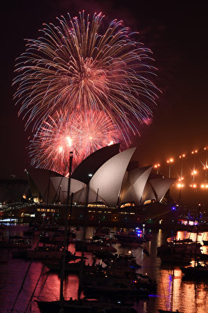 A family fireworks illuminates the sky above the iconic Opera House in Sydney on December 31, 2016, ahead of New Years fireworks. / AFP / SAEED KHAN (Photo credit should read SAEED KHAN/AFP/Getty Images)