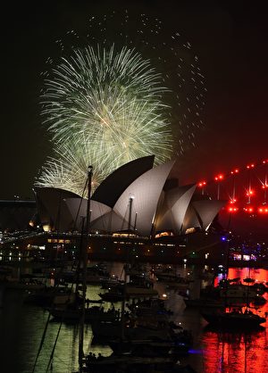 A family fireworks illuminates the sky above the iconic Opera House in Sydney on December 31, 2016, ahead of New Years fireworks. / AFP / SAEED KHAN (Photo credit should read SAEED KHAN/AFP/Getty Images)