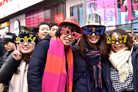 NEW YORK, NY - DECEMBER 31: People celebrate Japan New Years Countdown at Times Square on December 31, 2016 in New York City. (Photo by Eugene Gologursky/Getty Images for TOSHIBA CORPORATION)