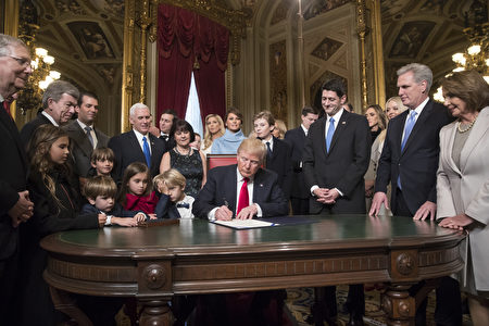 WASHINGTON, DC - JANUARY 20: President Donald Trump is joined by the Congressional leadership and his family as he formally signs his cabinet nominations into law, in the President's Room of the Senate, at the Capitol in Washington, January 20, 2017. From left are Senate Majority Leader Mitch McConnell, R-Ky., Sen. Roy Blunt, R-Mo., Donald Trump Jr., Vice President Mike Pence, Jared Kushner, Karen Pence, Ivanka Trump, Melania Trump, Barron Trump, Speaker of the House Paul Ryan, R-Wis., Majority Leader Kevin McCarthy, D-Calif., House Minority Leader Nancy Pelosi, D-Calif. (Photo by J. Scott Applewhite - Pool/Getty Images)