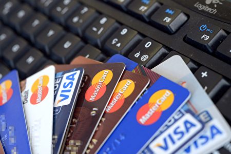 Credit cards are pictured on a computer's keyboard on February 5, 2013 in Rennes, western France. French police has arrested, early this morning in Paris and in several French and overseas departments, 22 people in connection with the trade of credit cards numbers on internet. AFP PHOTO DAMIEN MEYER / AFP / DAMIEN MEYER (Photo credit should read DAMIEN MEYER/AFP/Getty Images)