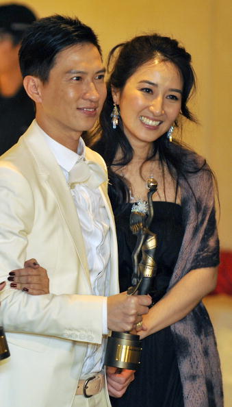 HONG KONG - APRIL 19: Hong Kong actor Nick Cheung (L) poses with his wife actress Esther Kwan after winning the Best Actor award for his role in "The Beast Stalker" during the 28th Hong Kong Film Awards 2009 at the InterContinental Hong Kong hotel on April 19, 2009 in Hong Kong. (Photo by Victor Fraile/Getty Images)