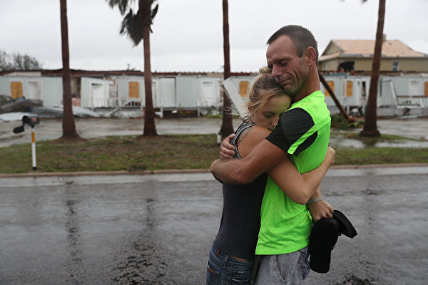 ROCKPORT, TX - AUGUST 26: Jessica Campbell hugs Jonathan Fitzgerald (L-R) after riding out Hurricane Harvey in an apartment on August 26, 2017 in Rockport, Texas. Jessica said is became very scary once Hurricane Harvey hit their town. Harvey made landfall shortly after 11 p.m. Friday, just north of Port Aransas as a Category 4 storm and is being reported as the strongest hurricane to hit the United States since Wilma in 2005. Forecasts call for as much as 30 inches of rain to fall by next Wednesday. (Photo by Joe Raedle/Getty Images)