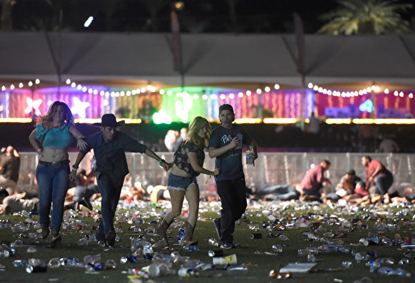 LAS VEGAS, NV - OCTOBER 01: People run from the Route 91 Harvest country music festival after apparent gun fire was heard on October 1, 2017 in Las Vegas, Nevada. There are reports of an active shooter around the Mandalay Bay Resort and Casino. (Photo by David Becker/Getty Images)