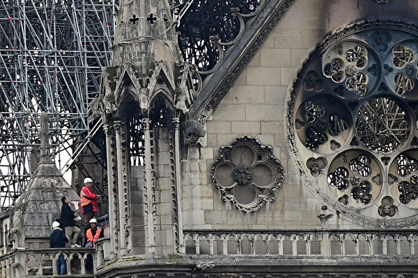 Inspectors are seen on the roof of the landmark Notre-Dame Cathedral in central Paris on April 16, 2019, the day after a fire ripped through its main roof. - A major fire broke out at the landmark Notre-Dame Cathedral in central Paris sending flames and huge clouds of grey smoke billowing into the sky, the fire service said. The flames and smoke plumed from the spire and roof of the gothic cathedral, visited by millions of people a year, where renovations are currently underway. (Photo by Lionel BONAVENTURE / AFP) (Photo credit should read LIONEL BONAVENTURE/AFP/Getty Images)