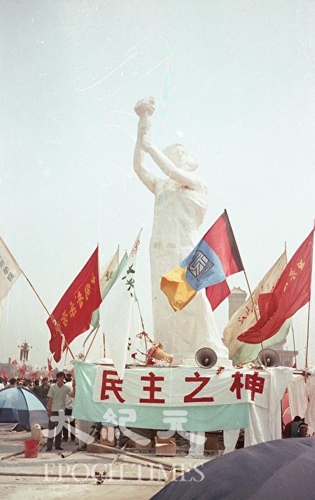 1989年六四前夕北京天安门广场的“民主之神”像，高约10米，是由中央美术学院、北京电影学院、中央戏剧学院、中央音乐学院、中国音乐学院、中央工艺美术学院、北京舞蹈学院等八所艺术院校的学生赶制而成；再用三轮车从中央美术学院运到天安门广场，并徒手搬运组装完成。“民主之神”像5月30日揭幕，6月4日凌晨被拉倒。（蒋一平提供）