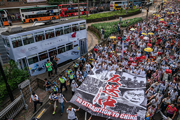 HONG KONG, HONG KONG - JUNE 09: Protesters march on a street during a rally against the extradition law proposal on June 9, 2019 in Hong Kong China. Hundreds of thousands of protesters marched in Hong Kong in Sunday against a controversial extradition bill that would allow suspected criminals to be sent to mainland China for trial.(Photo by