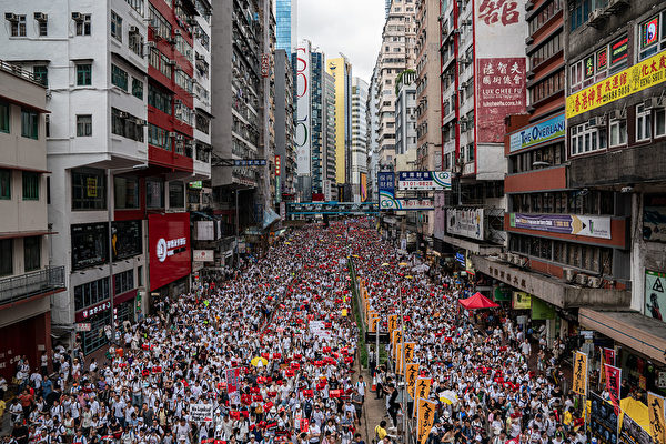 HONG KONG, HONG KONG - JUNE 09: Protesters march on a street during a rally against the extradition law proposal on June 9, 2019 in Hong Kong. Hundreds of thousands of protesters marched in Hong Kong in Sunday against a controversial extradition bill that would allow suspected criminals to be sent to mainland China for trial.(Photo by 