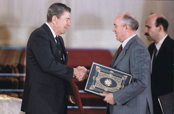 President Reagan and Soviet General Secretary Gorbachev shake hands after signing the INF Treaty