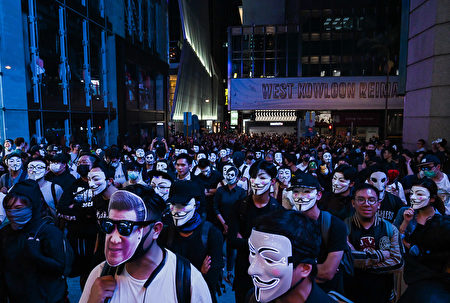 10月31夜万圣节前夜·，香港民众带着面具上街游行。