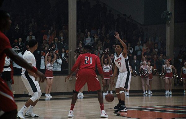 Brandon Wilson (with ball) leads his team in the high school basketball movie “The Way Back.” (Warner Bros.)