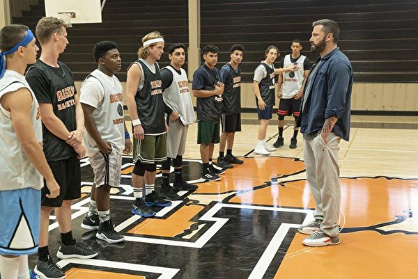 Jack (Ben Affleck, R) meets his team for the first time in the high school basketball movie “The Way Back.” (Warner Bros.)