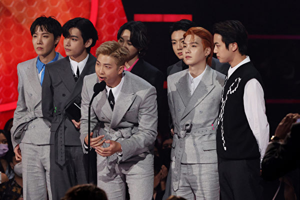 BTS accept the Artist of the Year award onstage during the 2021 American Music Awards